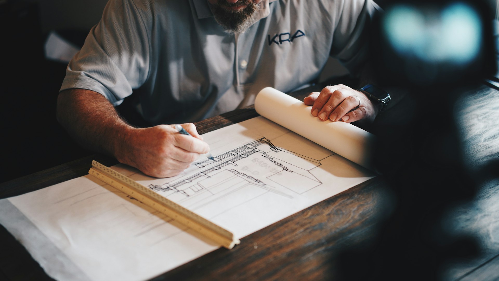 Handyman reviewing renovation plans for a property maintenance project