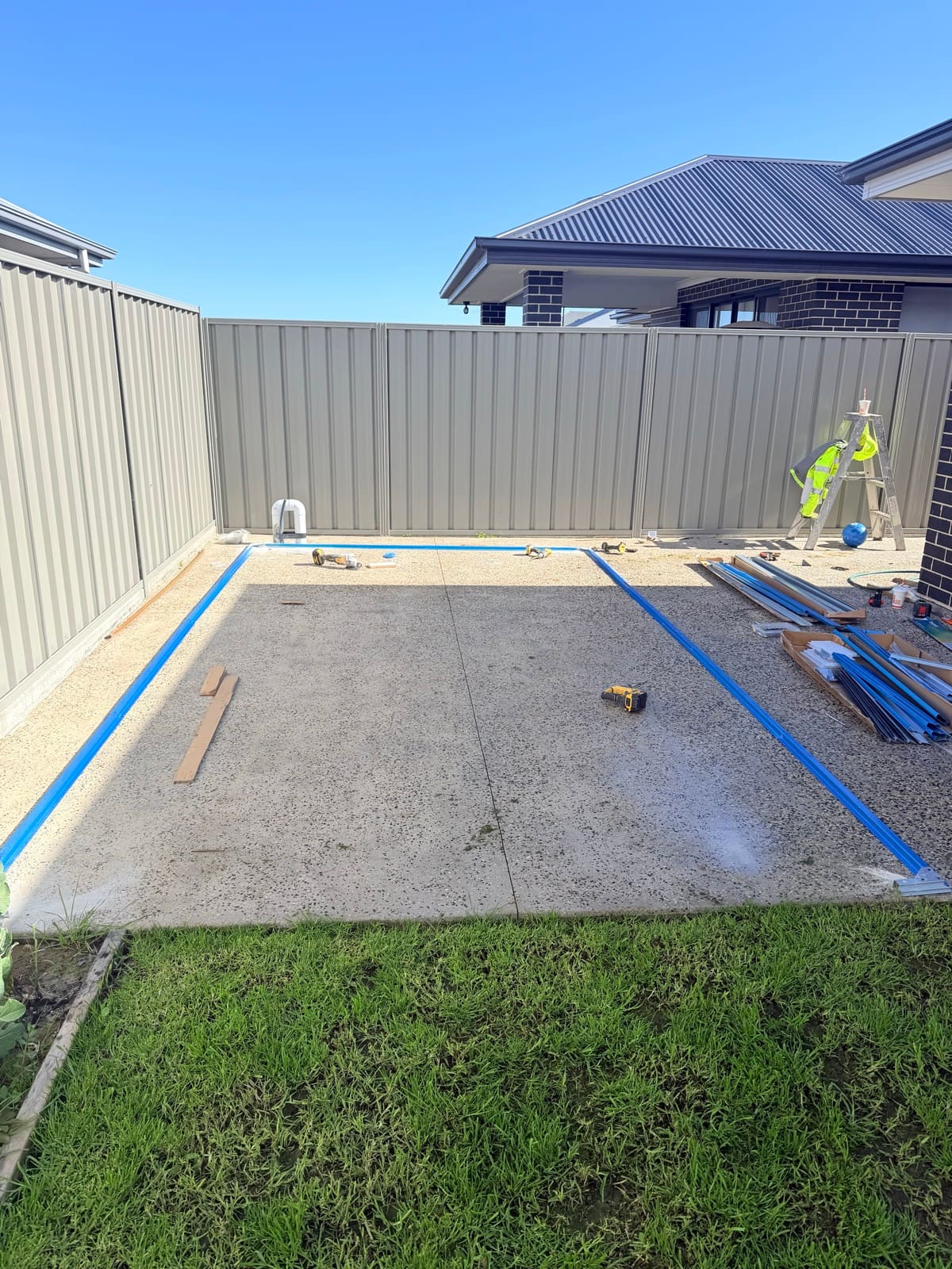 Garden shed base rails laid out on a concrete slab
